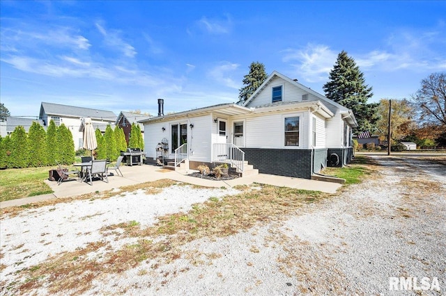 back of property with a patio area and brick siding