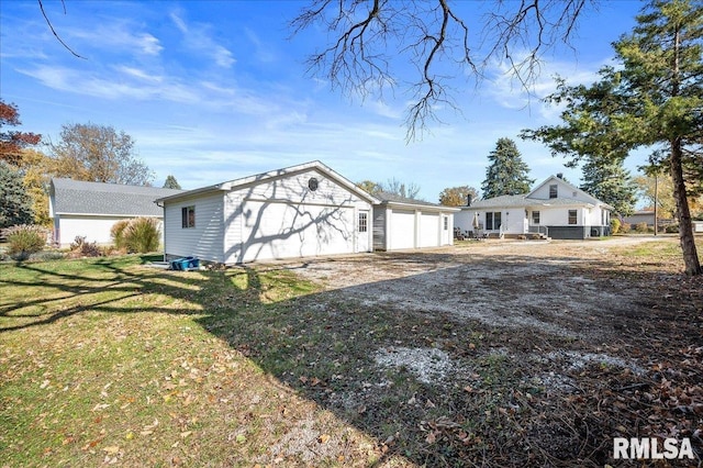 exterior space with an attached garage, driveway, and a front lawn