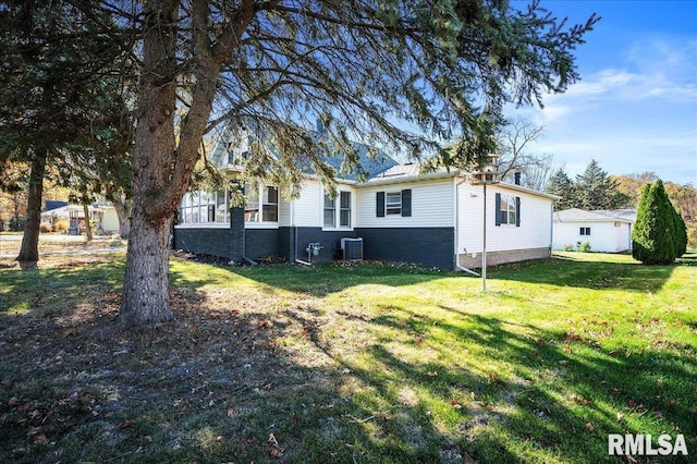 exterior space with a front yard and central AC unit