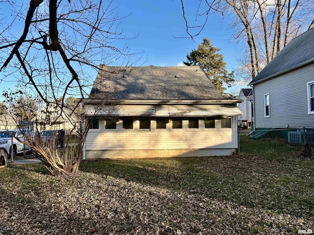 rear view of house with a shingled roof