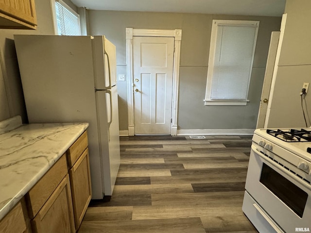 kitchen featuring light countertops, white appliances, dark wood finished floors, and baseboards