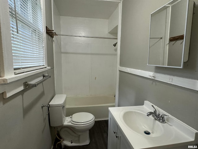 bathroom featuring bathing tub / shower combination, vanity, toilet, and wood finished floors