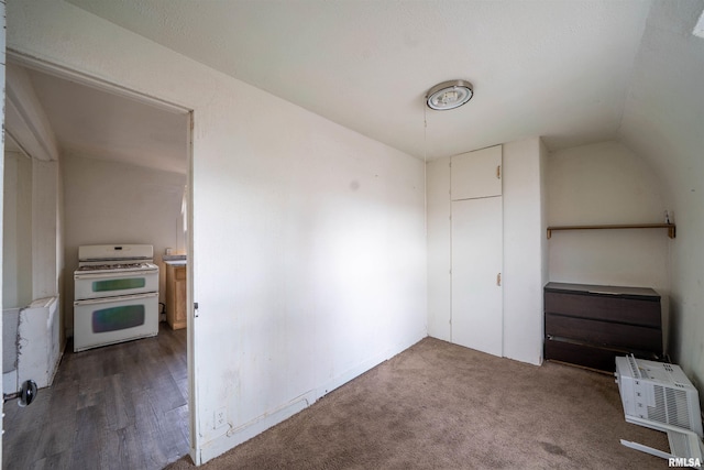 bonus room with lofted ceiling and dark carpet