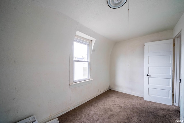 spare room featuring carpet floors and visible vents