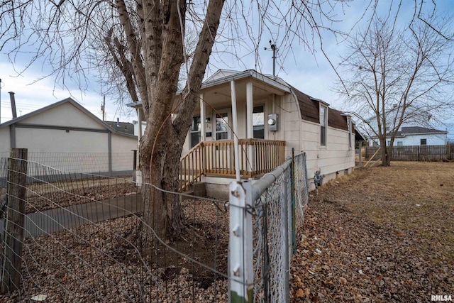 view of front facade with a porch, crawl space, and fence