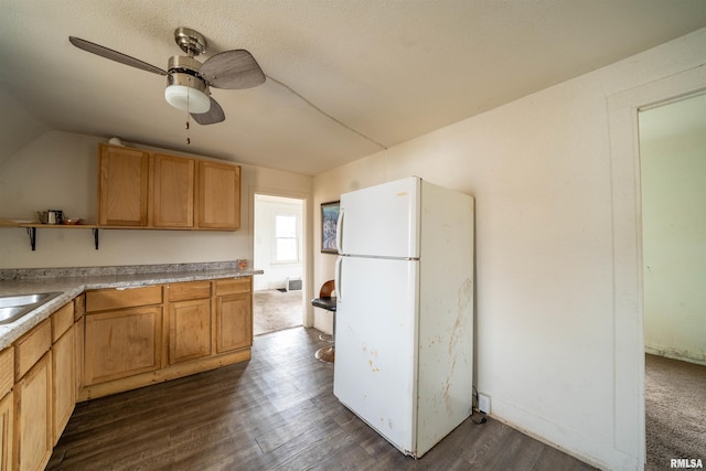 kitchen featuring ceiling fan, lofted ceiling, dark wood-style flooring, light countertops, and freestanding refrigerator