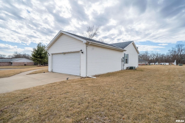 view of side of home featuring a garage and a lawn