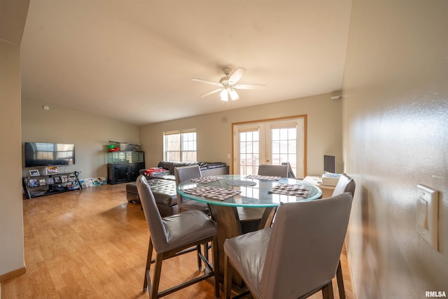 dining space featuring ceiling fan, french doors, wood finished floors, and lofted ceiling