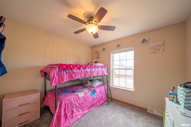 carpeted bedroom featuring baseboards, visible vents, and a ceiling fan