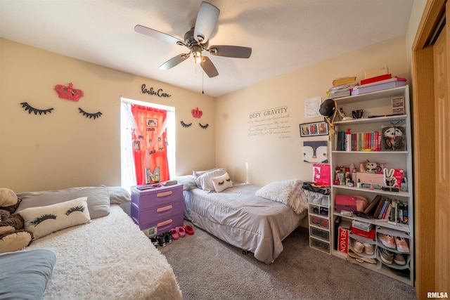 bedroom with a ceiling fan and carpet flooring