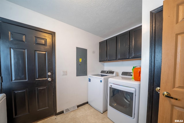 clothes washing area with cabinet space, electric panel, visible vents, washer and dryer, and a textured ceiling