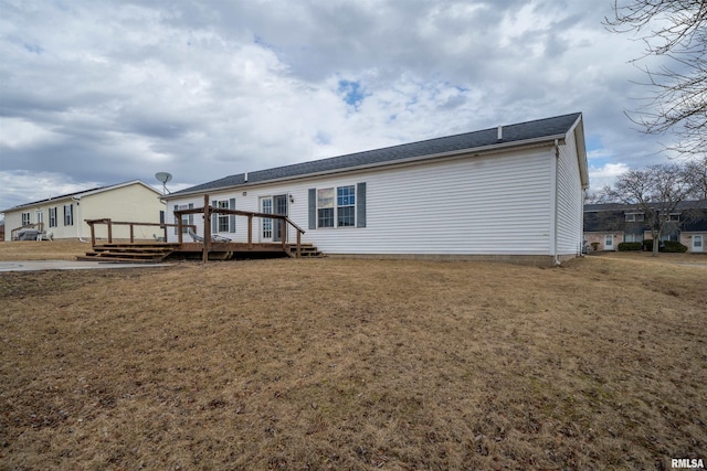 back of house featuring a yard and a deck