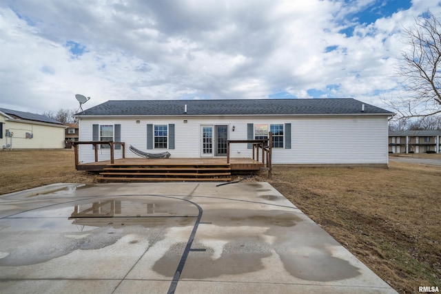 back of house featuring a yard, a patio area, and a wooden deck