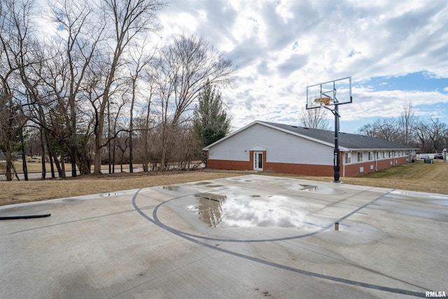 view of sport court featuring basketball hoop