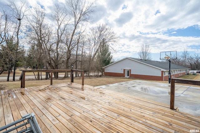 wooden terrace featuring basketball hoop