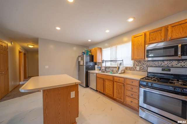 kitchen featuring marble finish floor, light countertops, backsplash, appliances with stainless steel finishes, and a kitchen island