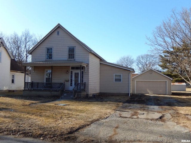 view of front of property with covered porch, a detached garage, and an outdoor structure