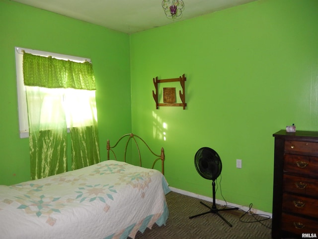 carpeted bedroom featuring baseboards