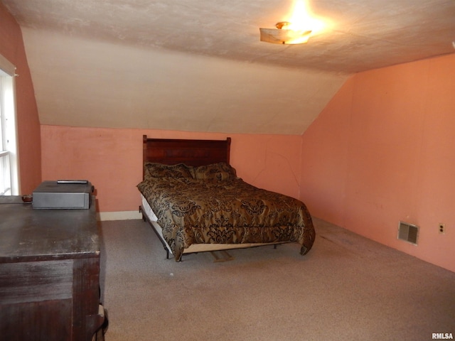 bedroom featuring carpet, visible vents, and vaulted ceiling