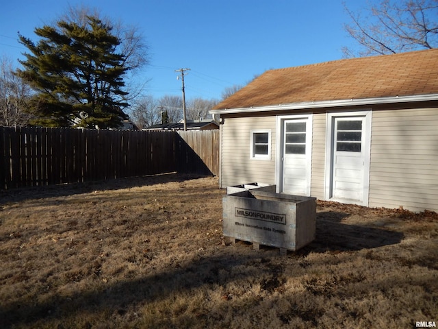 view of outbuilding featuring fence