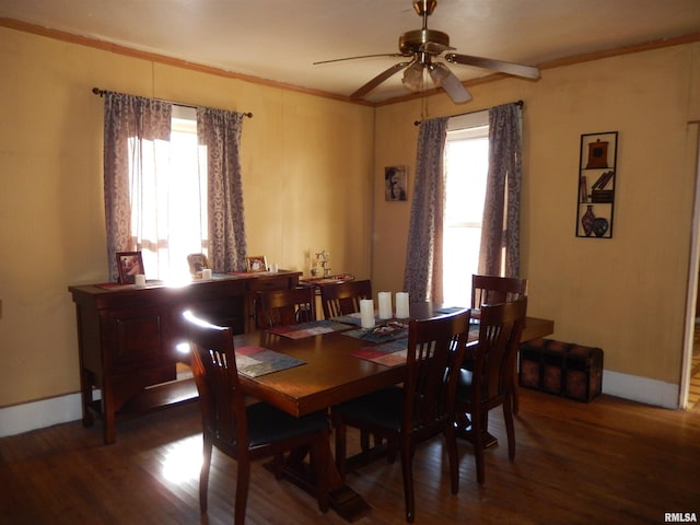 dining area featuring a wealth of natural light, ceiling fan, crown molding, and wood finished floors