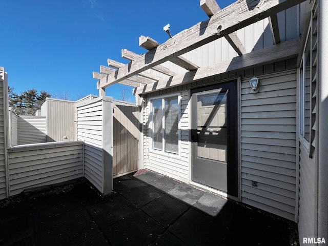 property entrance featuring a pergola