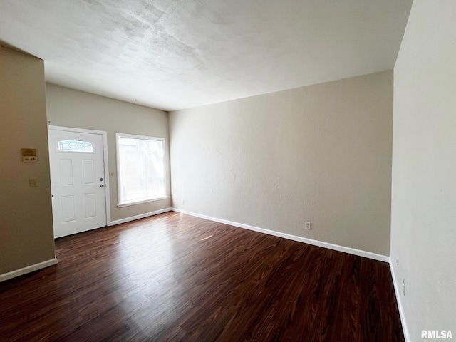 entryway featuring baseboards and wood finished floors