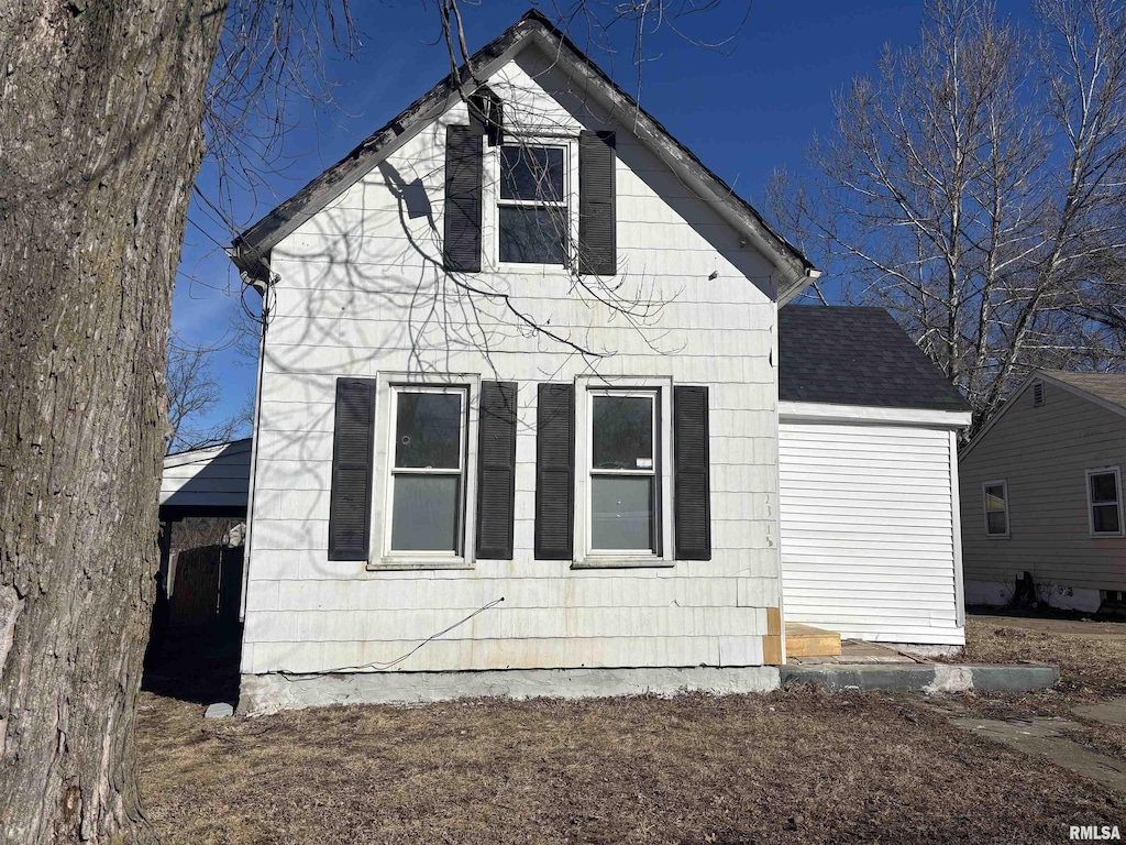 exterior space with roof with shingles