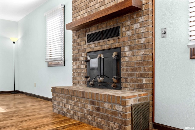 room details with baseboards, visible vents, and wood finished floors