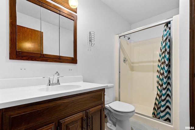 full bath featuring toilet, a stall shower, and vanity