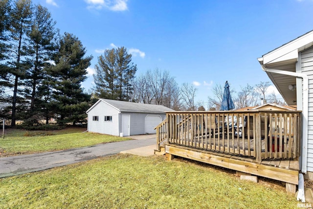 view of yard with an outbuilding, a detached garage, and a wooden deck