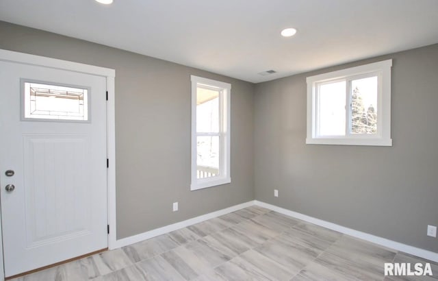 foyer with recessed lighting, visible vents, and baseboards