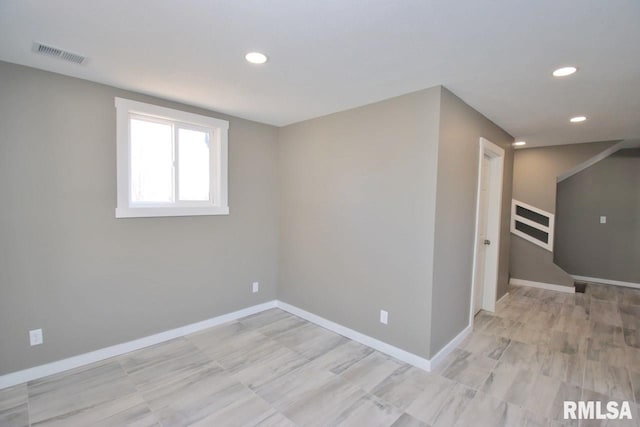 spare room featuring baseboards, visible vents, and recessed lighting