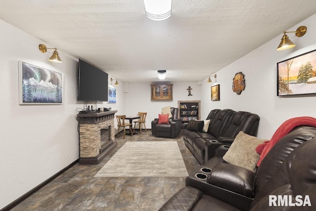 living area featuring baseboards, a stone fireplace, and a textured ceiling