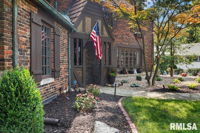 entrance to property featuring brick siding