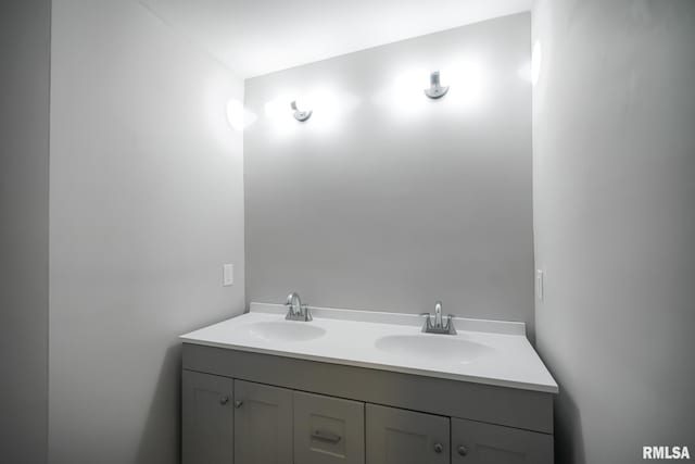 full bathroom featuring double vanity and a sink