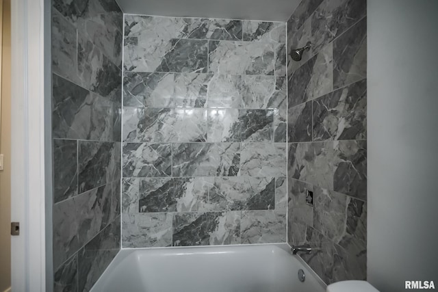 bathroom featuring washtub / shower combination and toilet