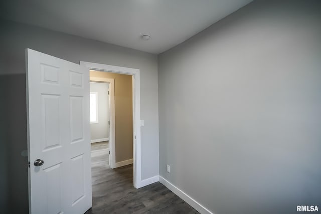 interior space with baseboards and dark wood finished floors