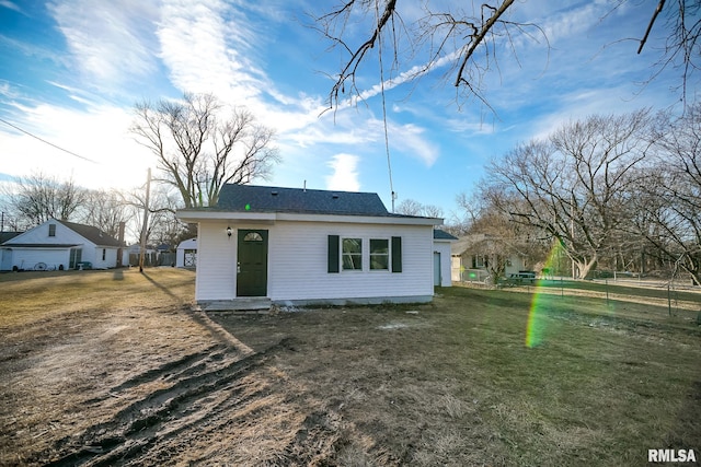 back of property with a lawn