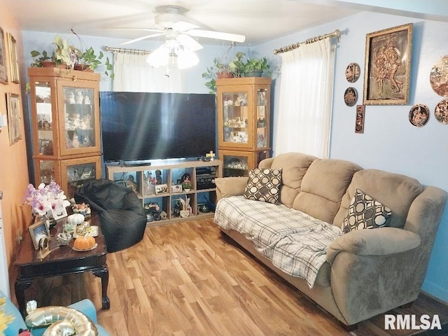 living room with ceiling fan and wood finished floors