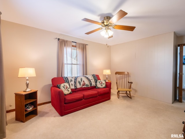 carpeted living room with ceiling fan