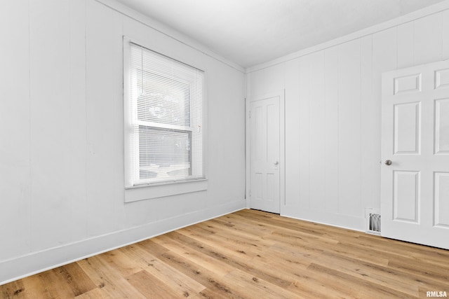 unfurnished room with light wood-style flooring and baseboards