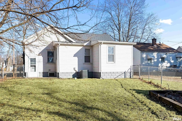 view of home's exterior with roof with shingles, fence, and a yard