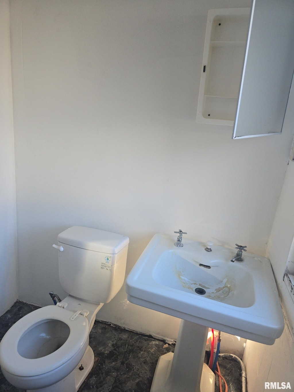 half bath featuring a sink and toilet