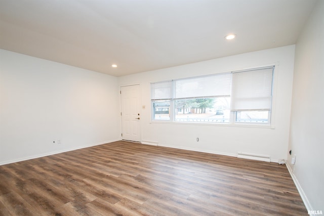 unfurnished room with baseboards, recessed lighting, wood finished floors, and a healthy amount of sunlight