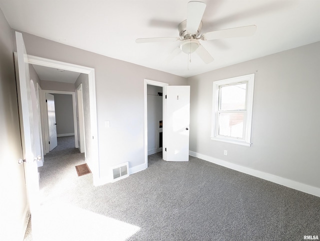 unfurnished bedroom with carpet floors, baseboards, visible vents, and ceiling fan