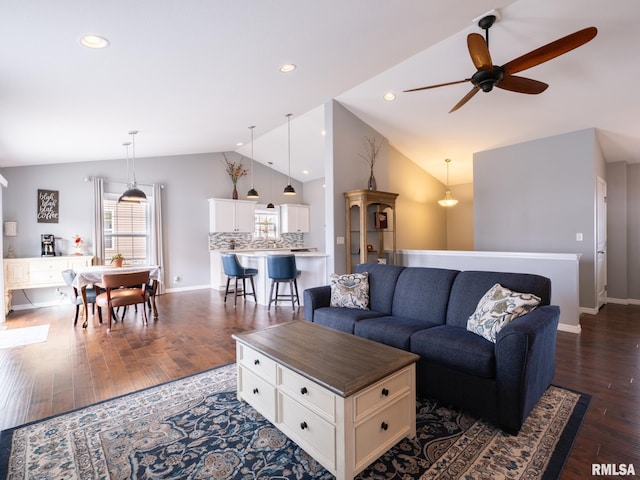 living area with vaulted ceiling, dark wood-type flooring, baseboards, and recessed lighting