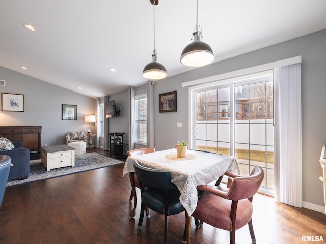 dining room featuring lofted ceiling, hardwood / wood-style flooring, and recessed lighting