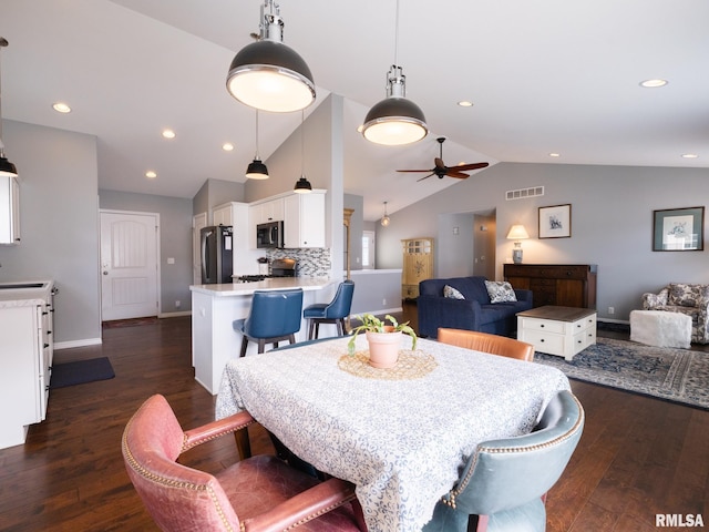 dining space featuring visible vents, a ceiling fan, lofted ceiling, dark wood-style floors, and recessed lighting