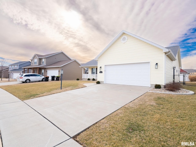 ranch-style house featuring an attached garage, driveway, a front yard, and a residential view